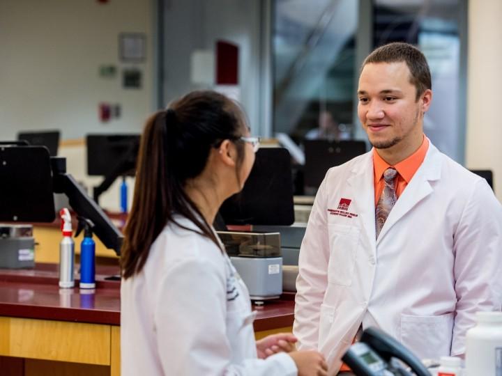 Two students talking in the pharmacy skills lab